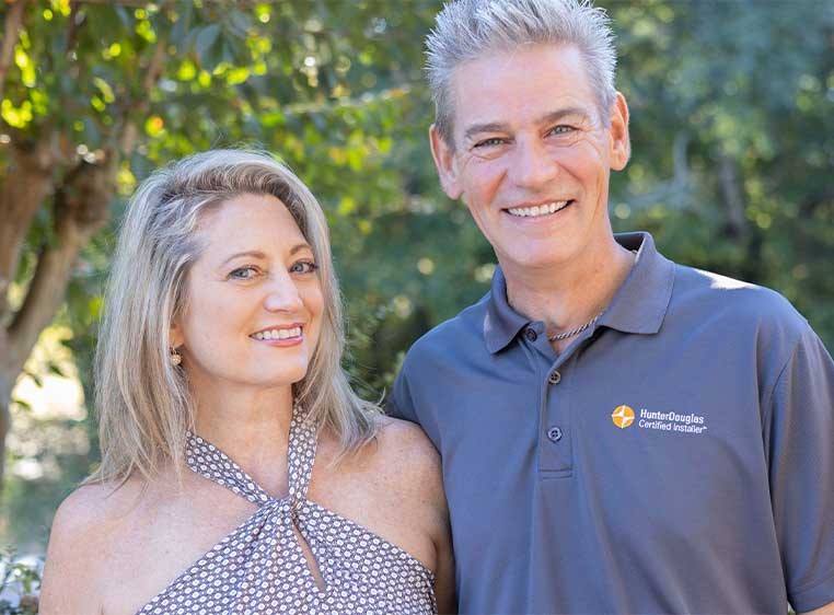 A smiling man and woman standing together