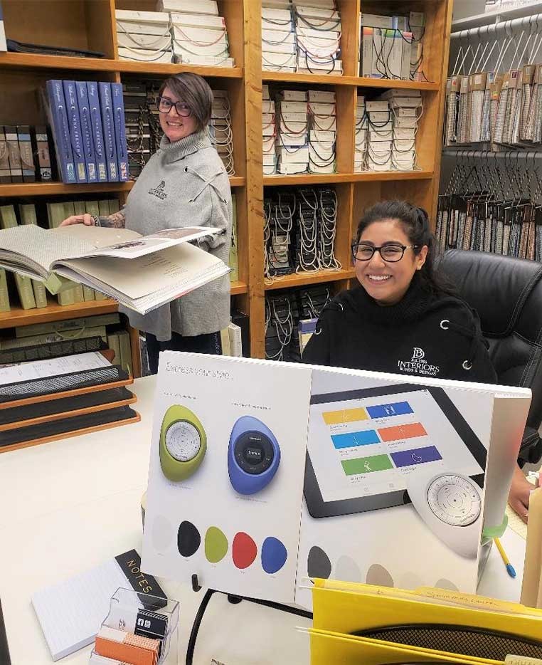 two smiling woman working